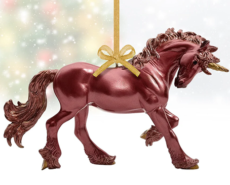 Metallic red unicorn ornament with gold horn and mane details, hanging for holiday décor in toys and games collections