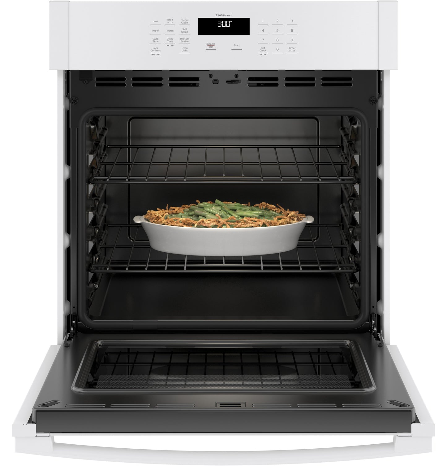 Open white built-in single wall oven from kitchen appliances collection with casserole dish inside on middle rack