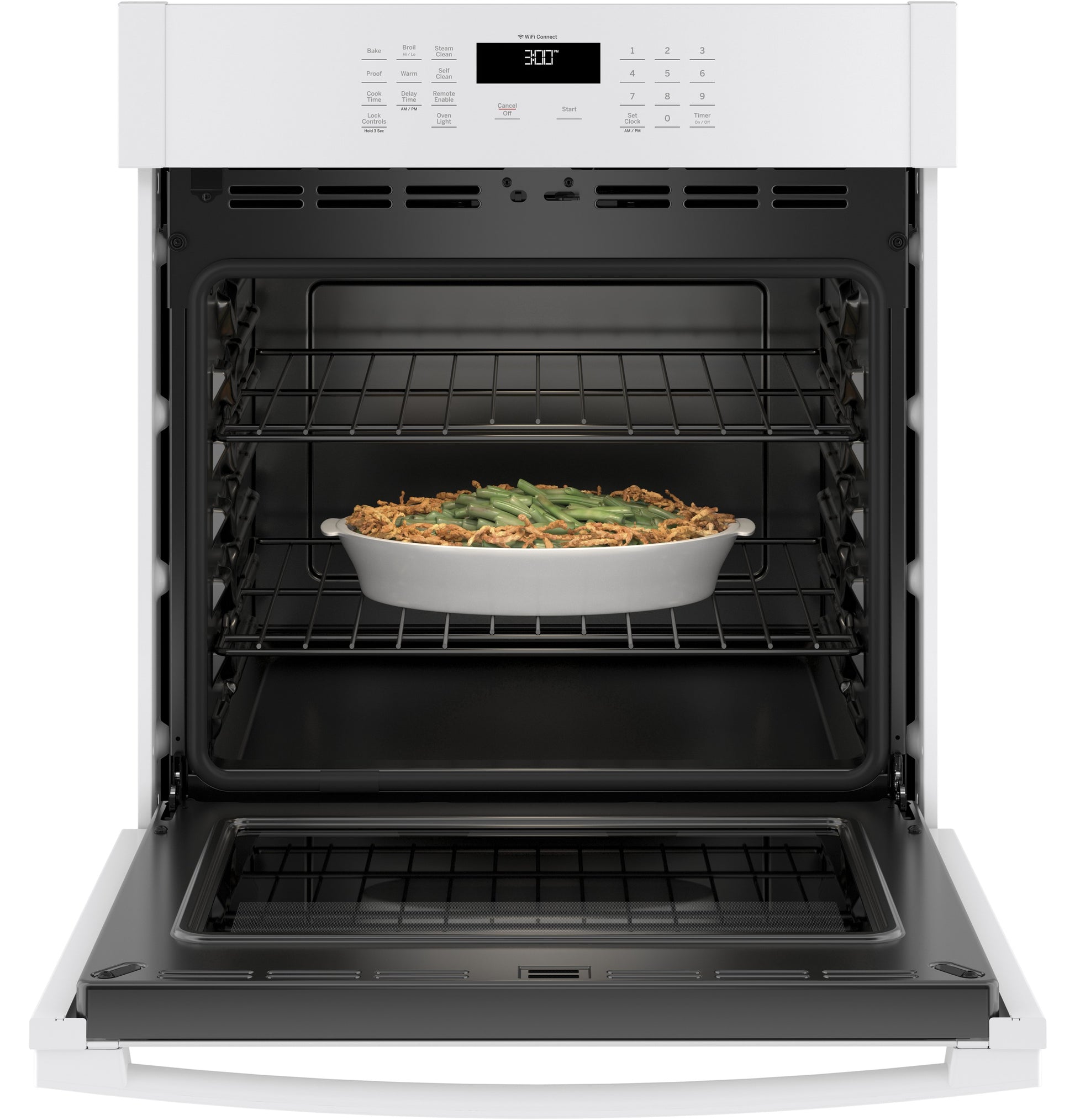 Open white built-in single wall oven from kitchen appliances collection with casserole dish inside on middle rack