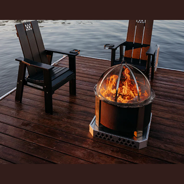Outdoor living setup with corten smokeless fire pit and wooden patio chairs on lakeside deck