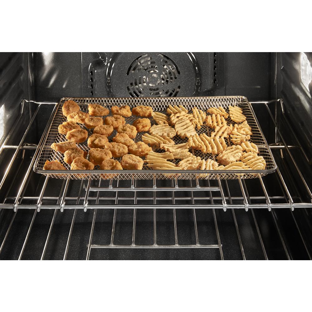 Food items crisping on air frying basket inside 30-inch wall oven microwave combo in kitchen appliance collection