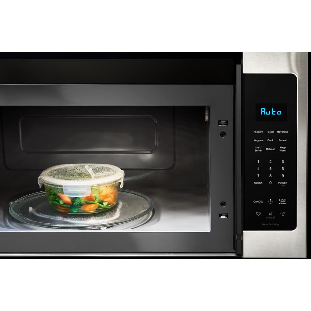 Stainless steel over the range microwave with digital control panel showing Auto mode and container of steamed vegetables inside