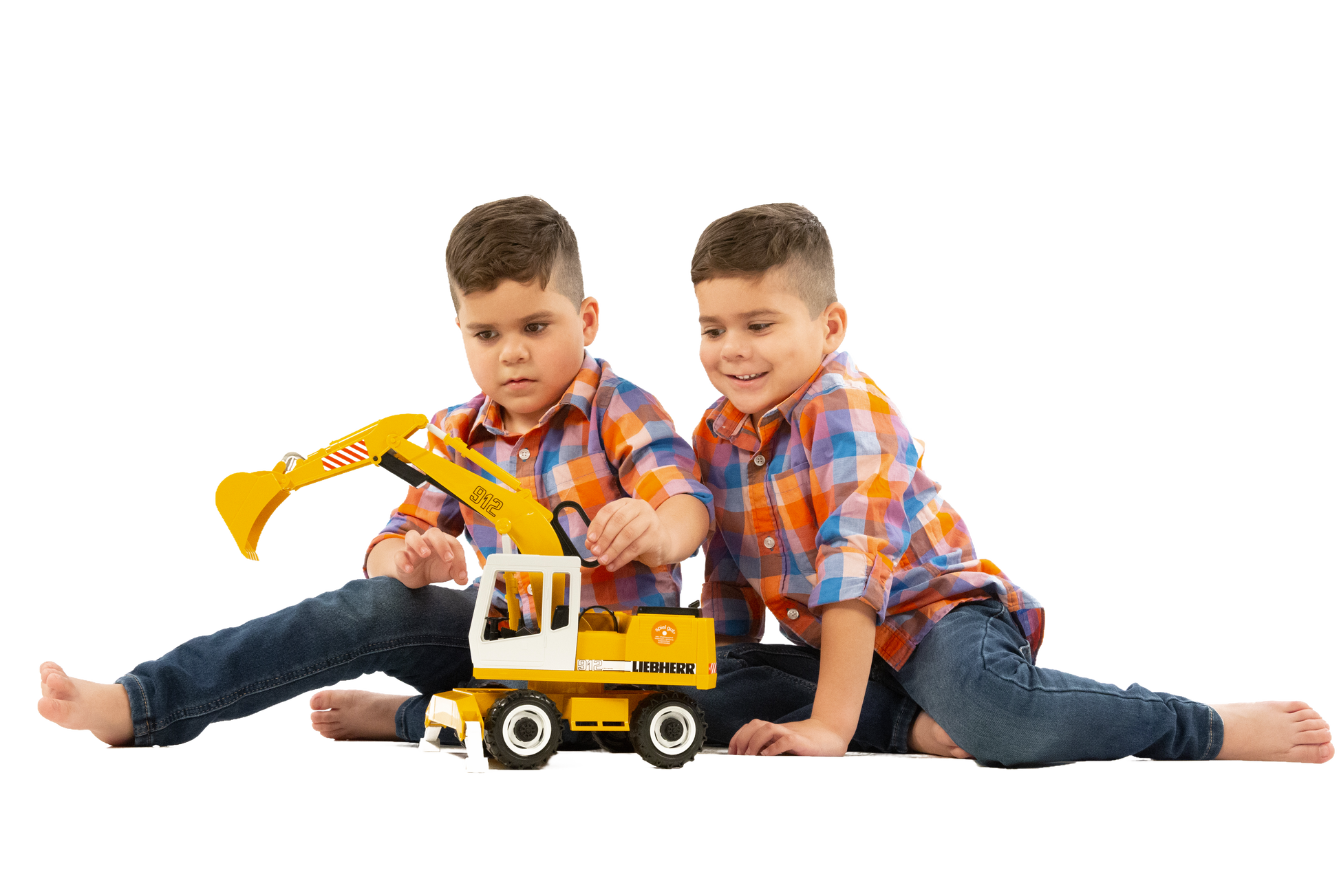 Two boys playing on floor with yellow Bruder Liebherr Power Shovel toy from Vehicles & Remote Controlled Toys collection