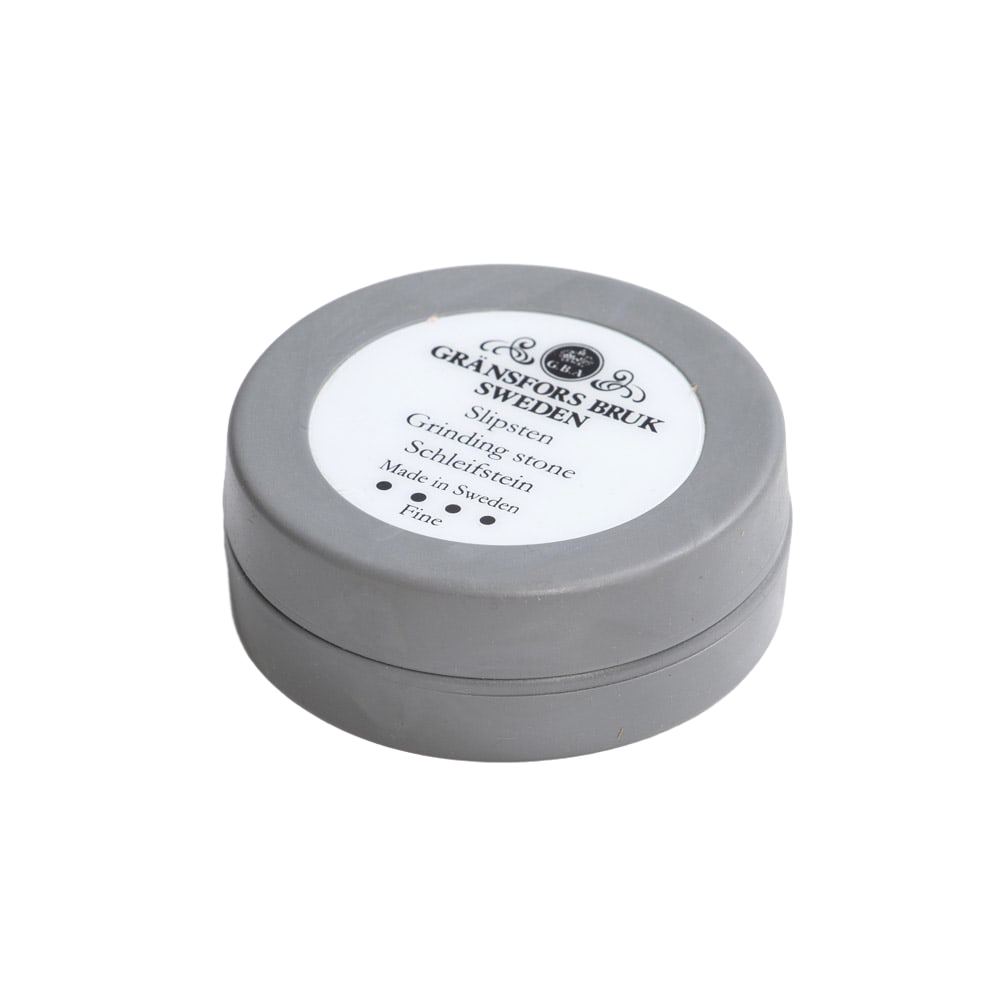 Round gray container of fine ceramic grinding stone for tool sharpening in woodworking tool accessories collection