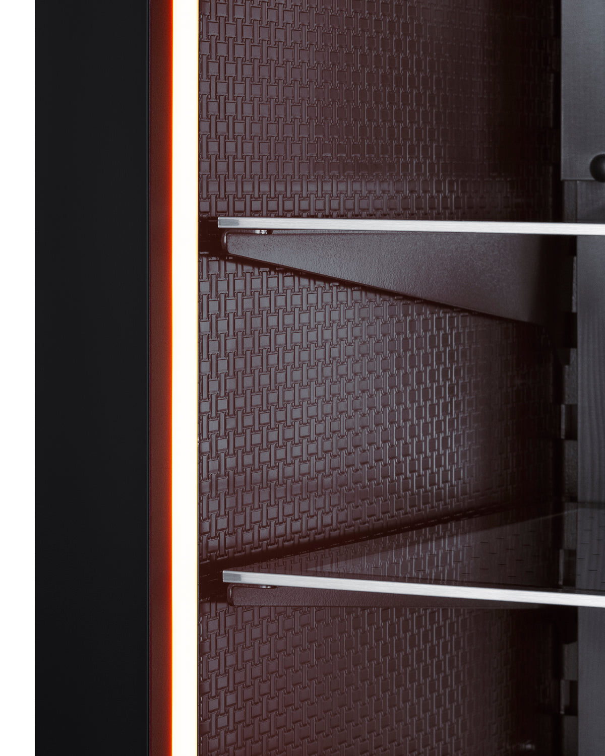 Close-up of textured dark interior wall with metal shelves inside a built-in beverage center appliance.