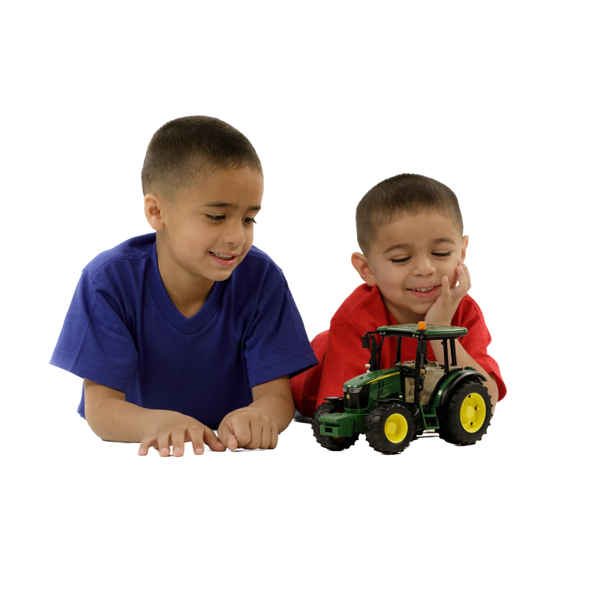 Two young boys playing with a green and yellow Bruder John Deere 5115 M Tractor toy from Vehicles & Remote Toys