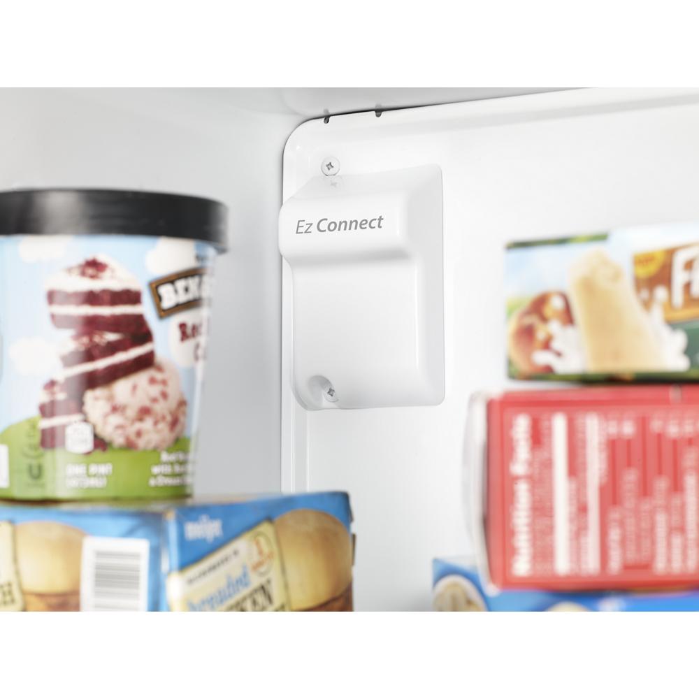 Close-up of ice maker connection labeled Ez Connect inside top freezer refrigerator compartment with frozen goods nearby