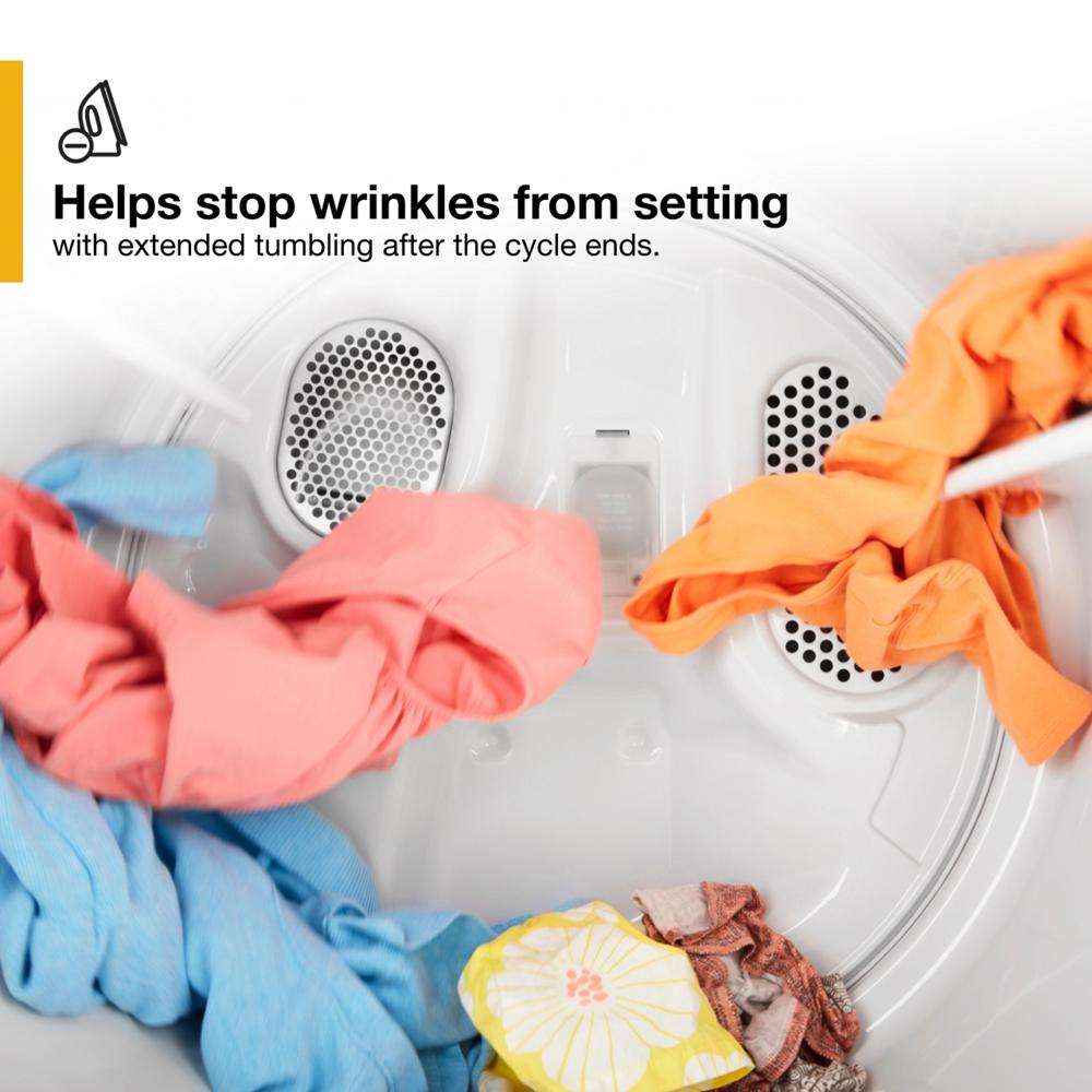Inside view of large-capacity dryer drum tumbling colorful clothes to prevent wrinkles setting after drying cycle.