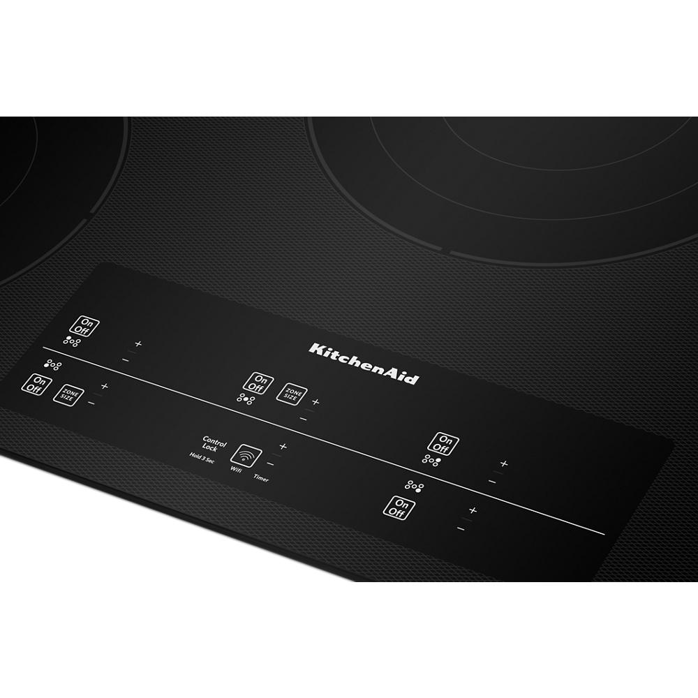 Close-up of black glass electric cooktop with touch-activated controls from KitchenAid's Cooktops and Appliances collections