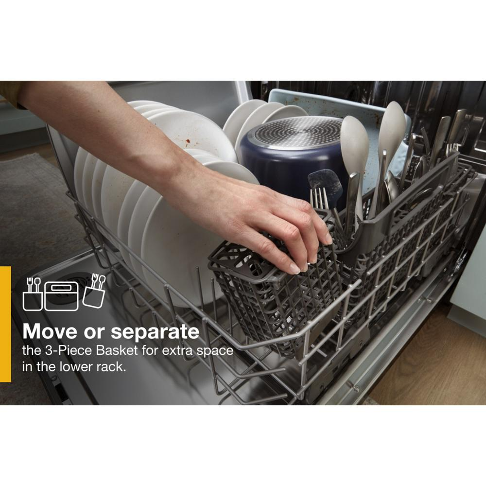 Hand adjusting the removable silverware basket inside a stainless steel dishwasher lower rack loaded with dishes.