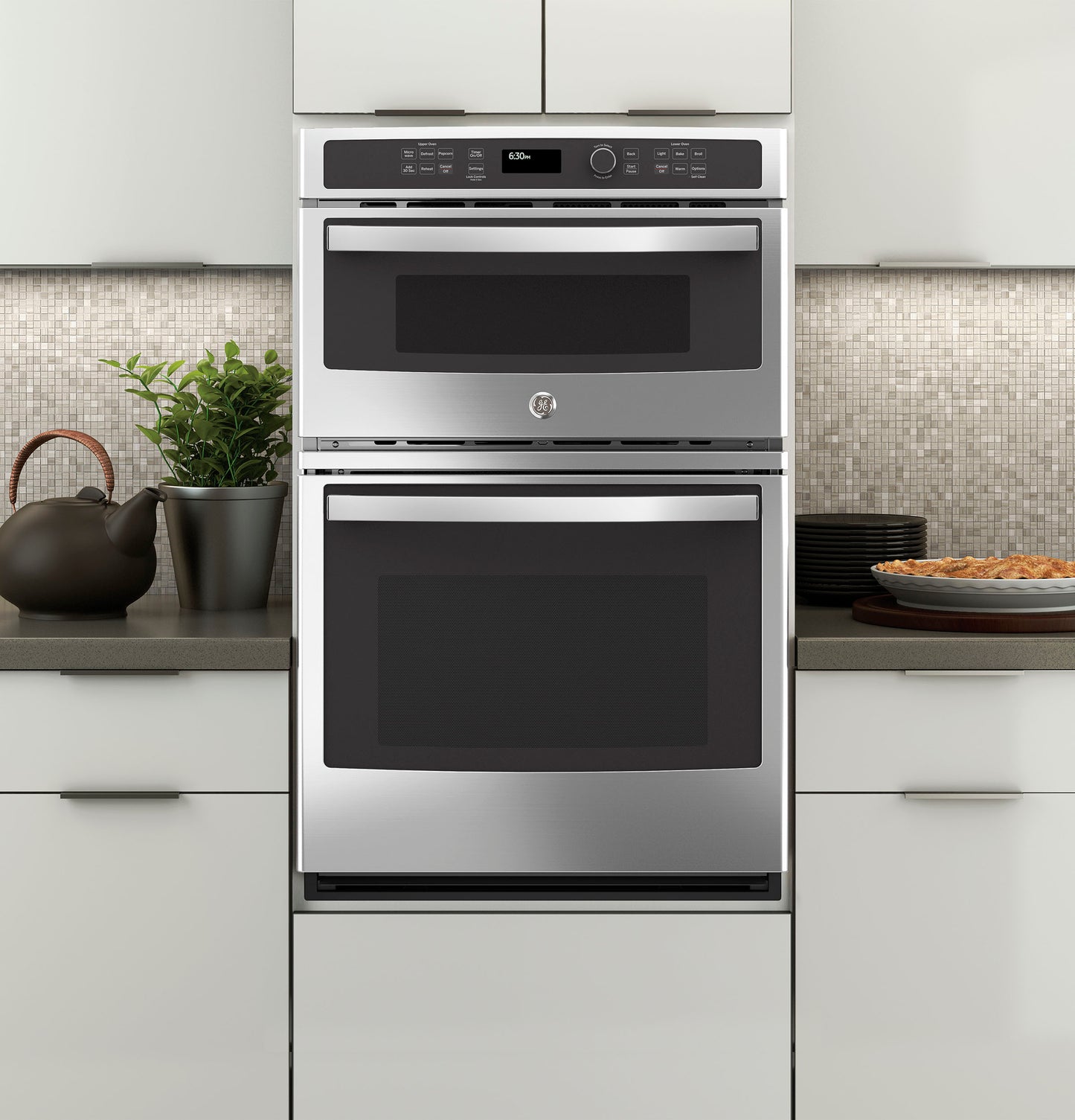 Stainless steel built-in microwave and thermal wall oven combo installed in a modern kitchen setting