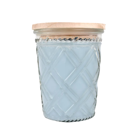 Glass jar candle with pale blue wax and textured crisscross pattern topped with a natural wood lid
