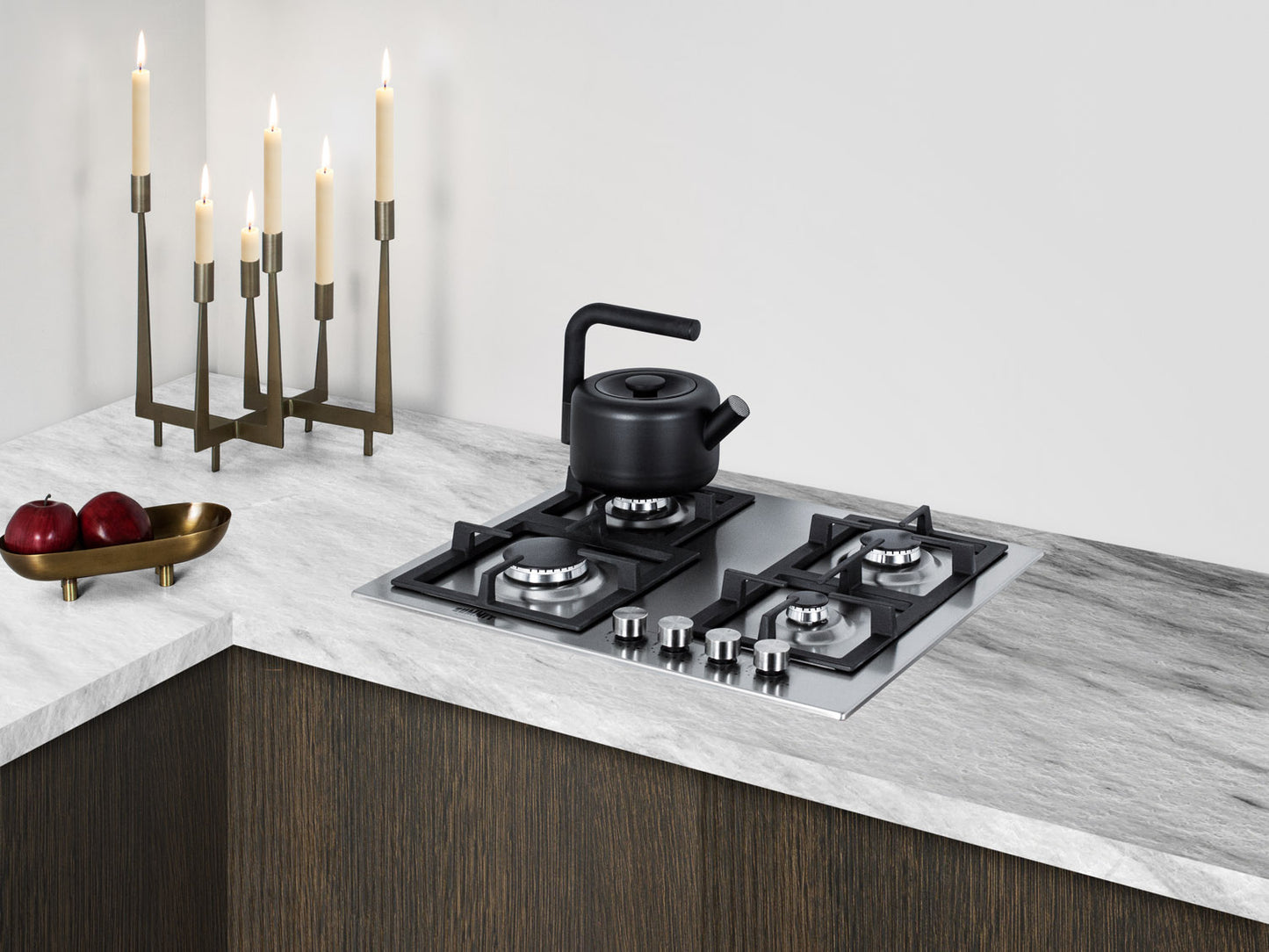 Modern 24-inch stainless steel propane cooktop with four burners and black kettle in kitchenware appliances setting