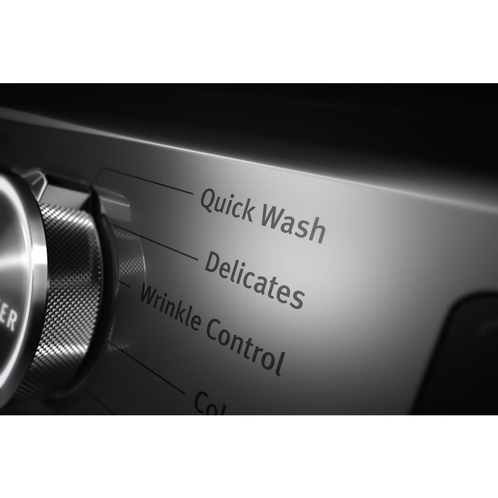 Close-up of metallic control knob with cycle options Quick Wash, Delicates, and Wrinkle Control on front load washer in appliances collection