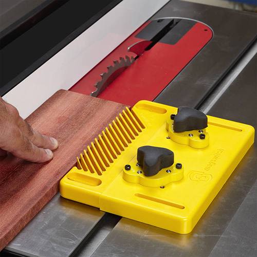 Yellow woodworking tool accessory used for securing wood on a table saw in woodworking tools and home improvement collections