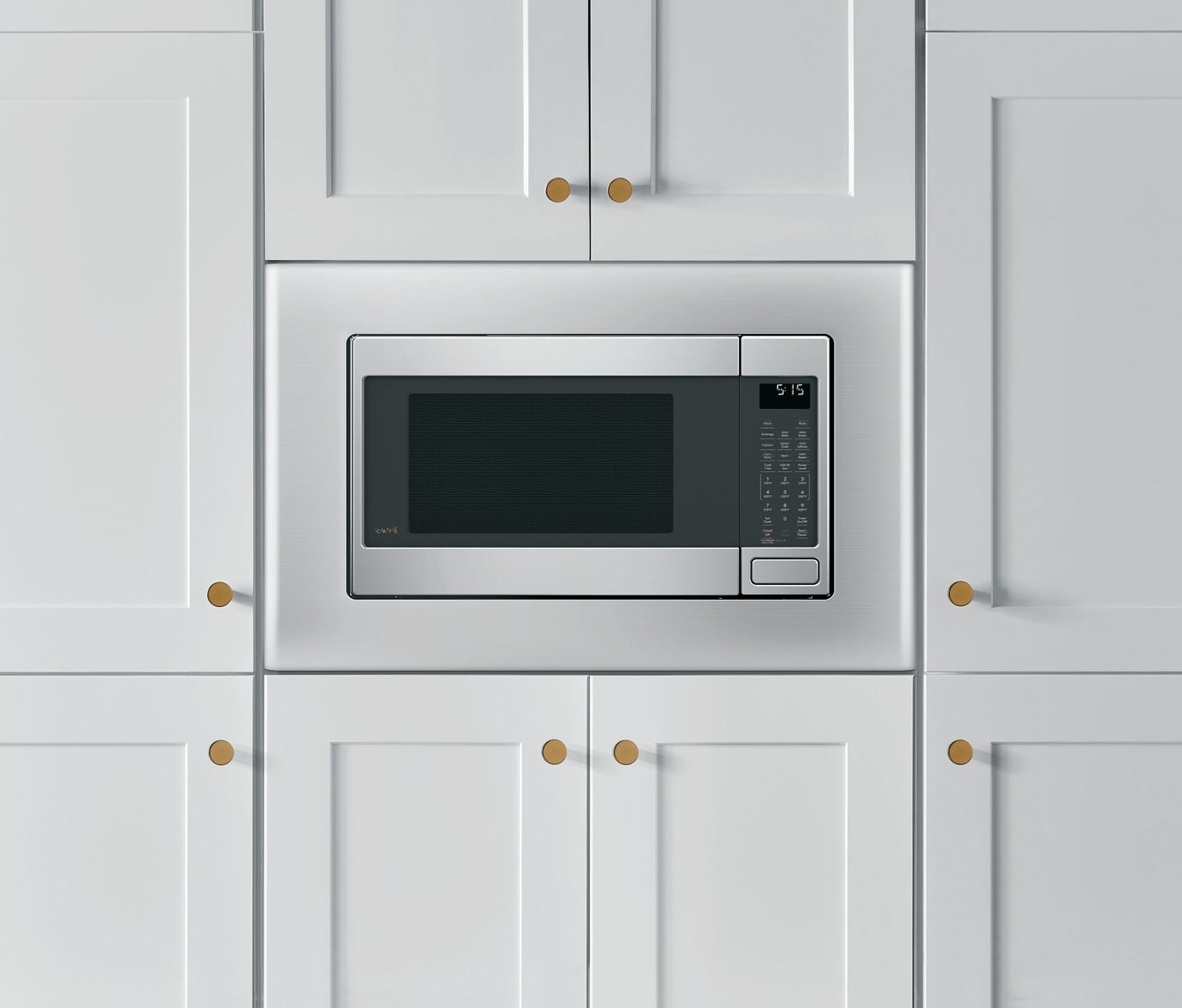 Built-in stainless steel microwave trim kit installed in white kitchen cabinetry from appliances collection