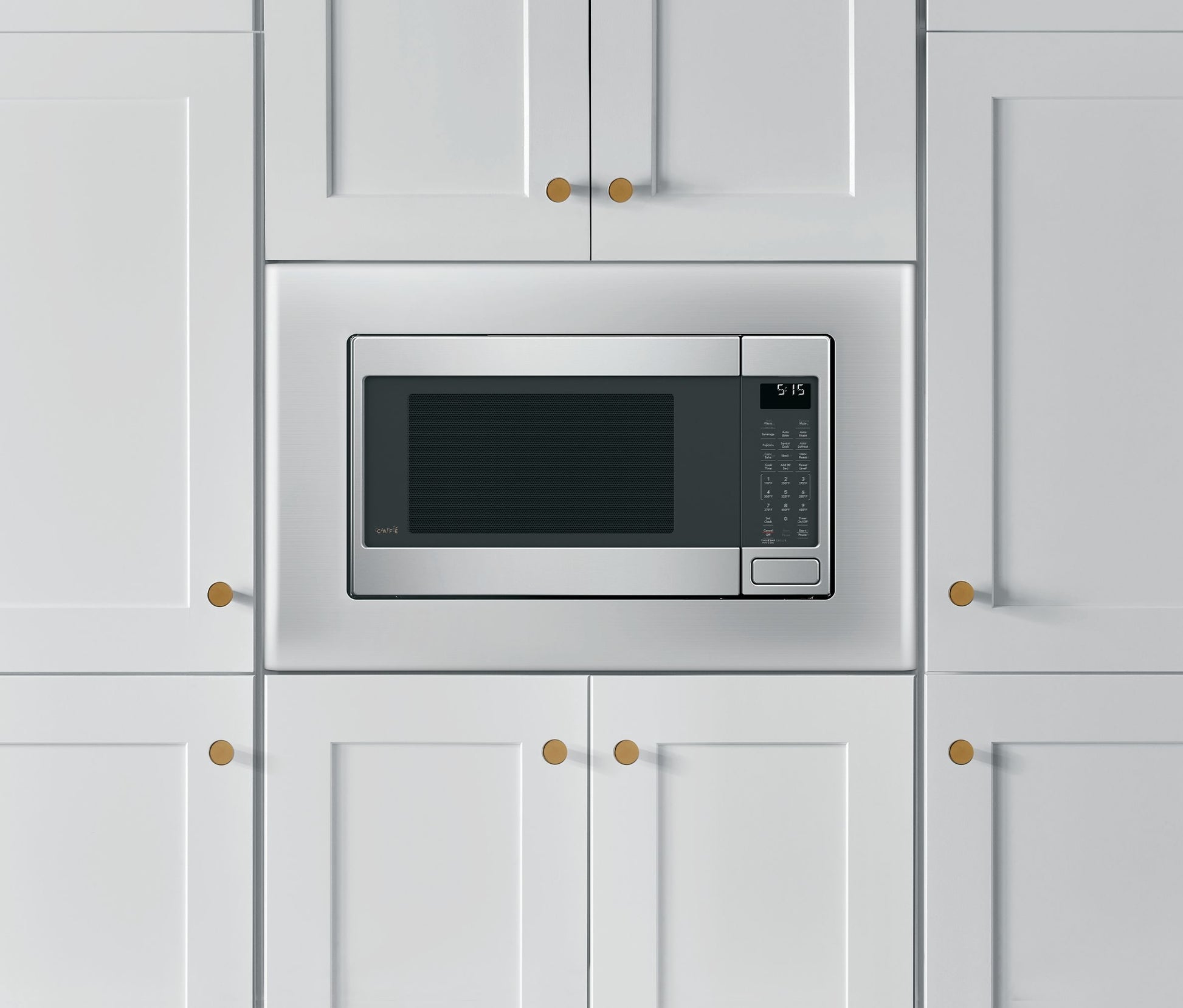 Built-in stainless steel microwave trim kit installed in white kitchen cabinetry from appliances collection