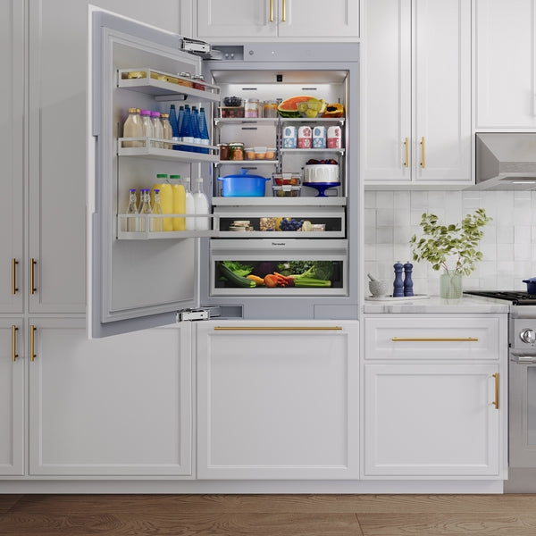 Built-in bottom freezer refrigerator with panel-ready design and organized interior in Thermador Appliances collection
