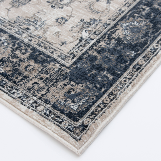 Corner of area rug with detailed blue, grey, and beige pattern for rugs and home decor collections