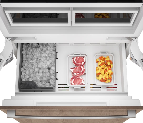 Open built-in bottom freezer drawer with organized frozen foods and built-in ice compartment in modern kitchen appliance