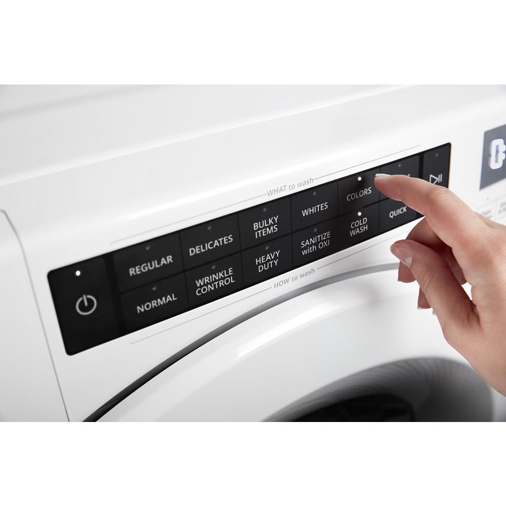 Close-up of fingertip selecting wash cycle options on a white front load washer control panel from Front Load Washers collection