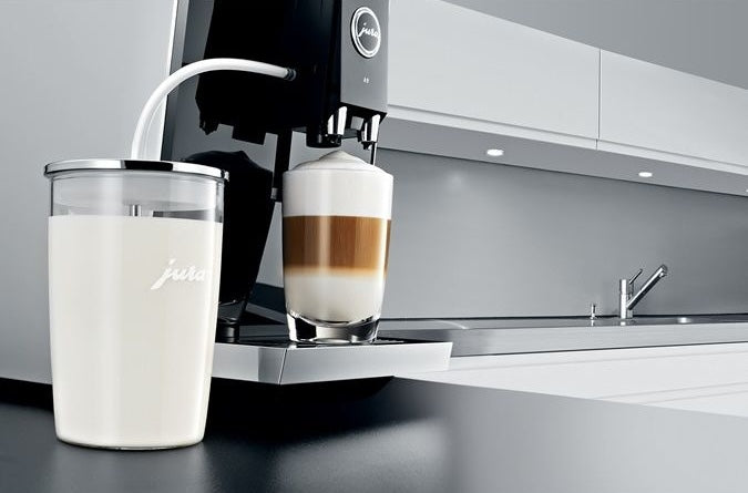 Transparent glass container with silver lid holding milk, used with coffee machine in kitchen gadgets and under $50 collection