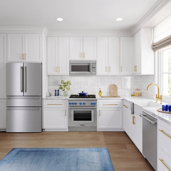 Modern kitchen featuring a stainless steel French door refrigerator with bottom freezer amid white cabinetry and gold hardware accents
