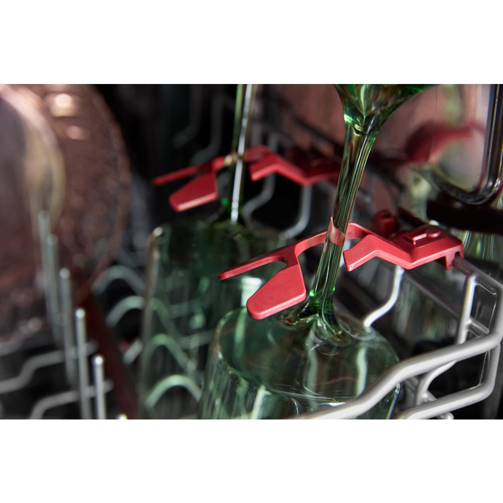 Close-up of dishwasher rack securely holding glassware with red stemware clips for safe and efficient cleaning.