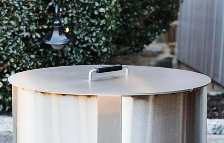 Stainless steel fire pit lid with black handle for outdoor living and patio furniture fire pits collection