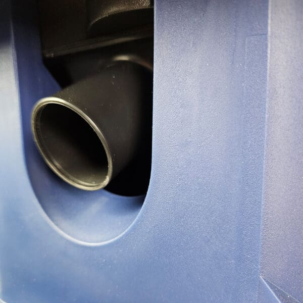 Close-up of black dust port on blue benchtop sander for power tools and home improvement projects