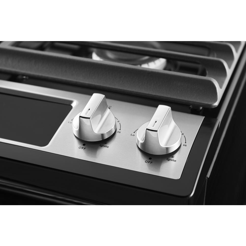 Close-up of stainless steel cooktop burner control knobs on gas range from Ranges collection