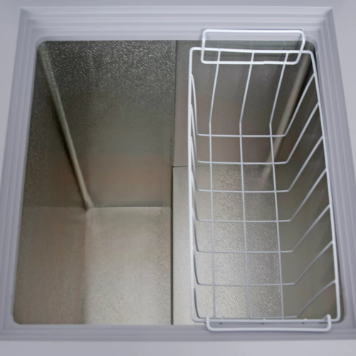 Empty interior of a garage ready chest freezer with removable white wire storage basket from Freezers & Ice Makers collection