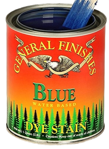 Open can of blue water based dye stain with paintbrush dipped in paint for home improvement and woodworking tools