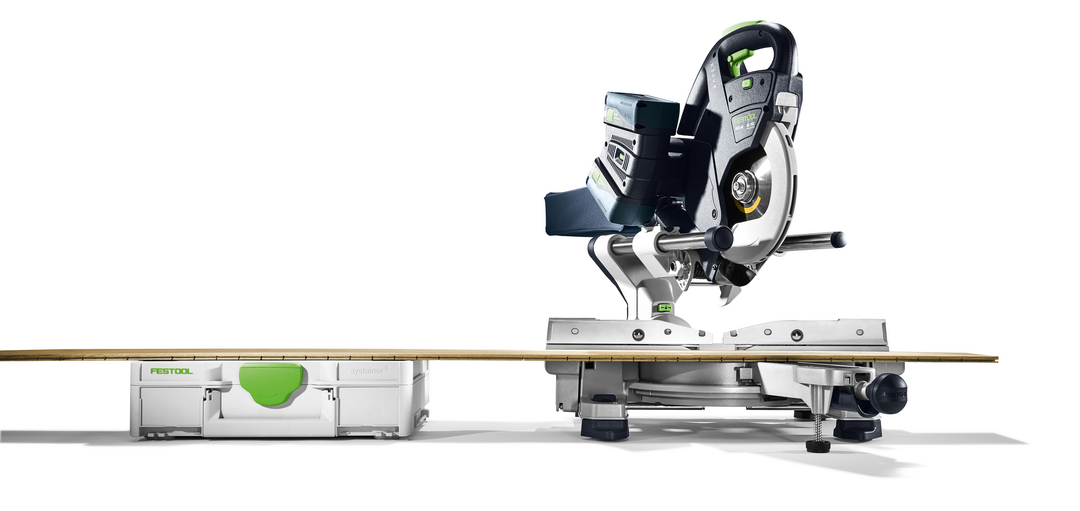 Side view of Festool cordless sliding compound miter saw with wooden plank and integrated storage case in power tools collection