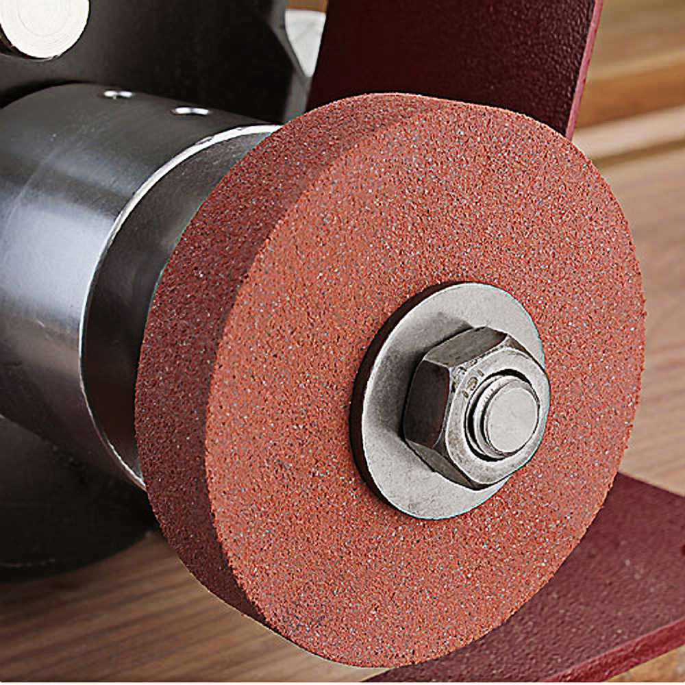 Close-up of a red abrasive honing wheel attached to a metal tool for home improvement tasks