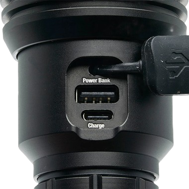 Close-up of black rechargeable tactical flashlight showing USB power bank and charging ports in hand tools collection