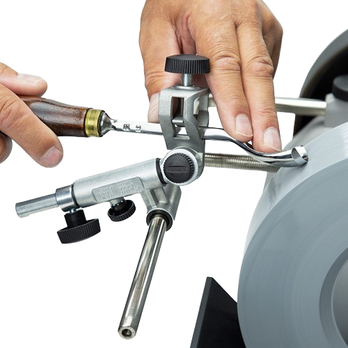 Person sharpening gouge tool with Tormek SVD-186 R Gouge Jig on grinding wheel for precise home improvement work