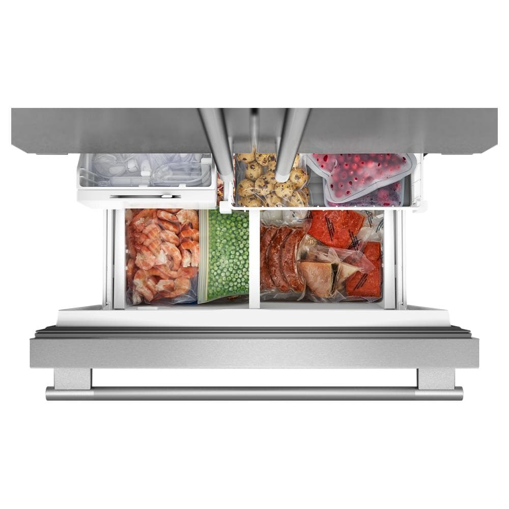 Top view of freezer drawer neatly organized with frozen vegetables, shrimp, berries, and packaged meat in stainless steel fridge drawer