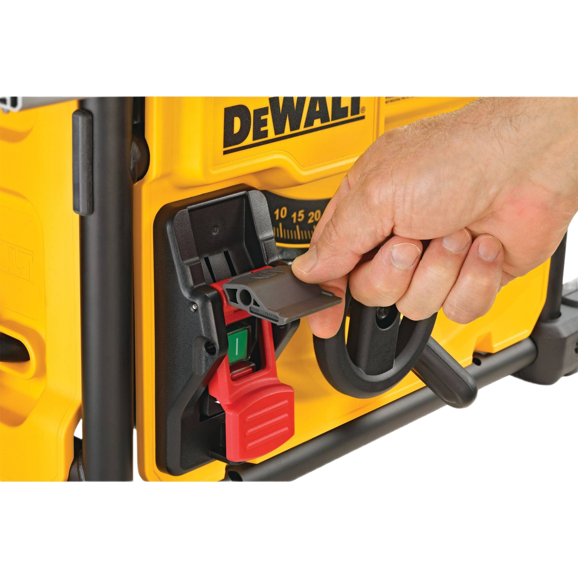 Hand adjusting power switch cover on yellow DEWALT jobsite table saw for woodworking and home improvement tools collections