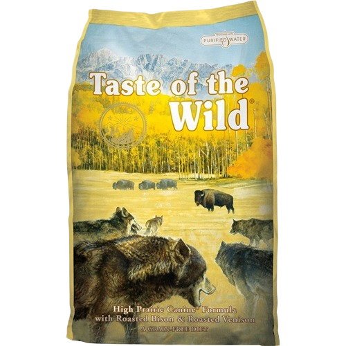 Bag of dry dog food featuring a wilderness scene with wolves, bison, and autumn forest background