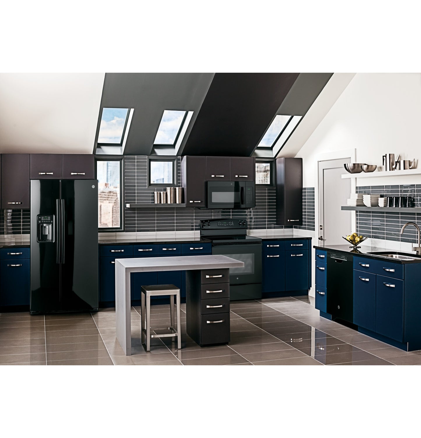 Modern kitchen with navy and black cabinetry, built-in microwave above black electric range, and sleek island seating area