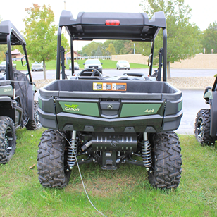 Rear view of a green mid-size utility vehicle with 4x4 drivetrain and rugged suspension for outdoor tasks