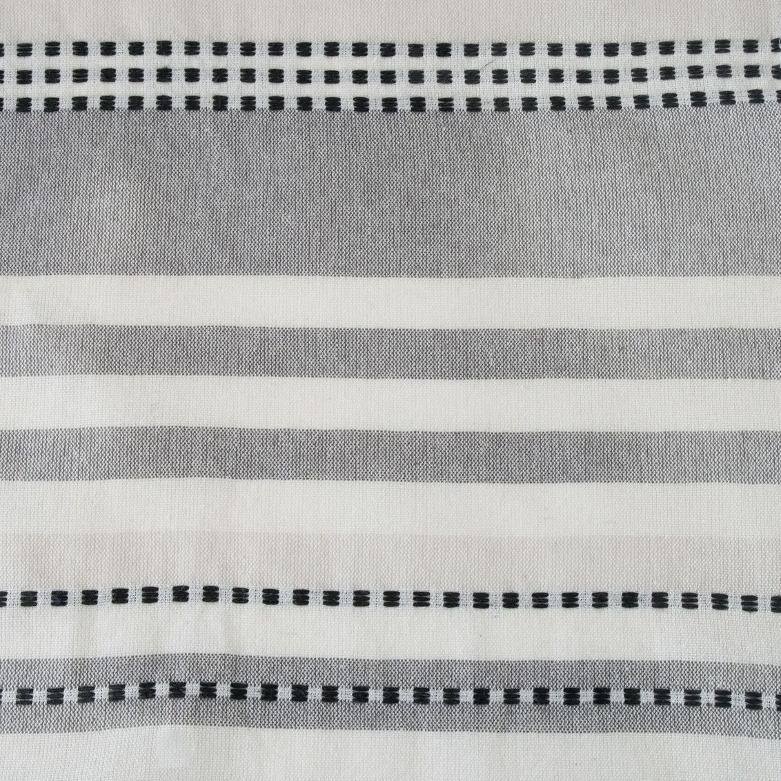 Close-up of white cotton fabric with gray stripes and dotted black lines for bathroom shower curtain collections under $100