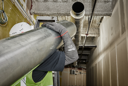 Gray protective sleeve with cut level 5 rating worn for arm safety during industrial tools and home improvement work