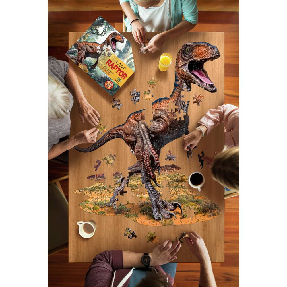 People assembling a colorful raptor-shaped 100-piece puzzle on a wooden table from Toys & Games collection