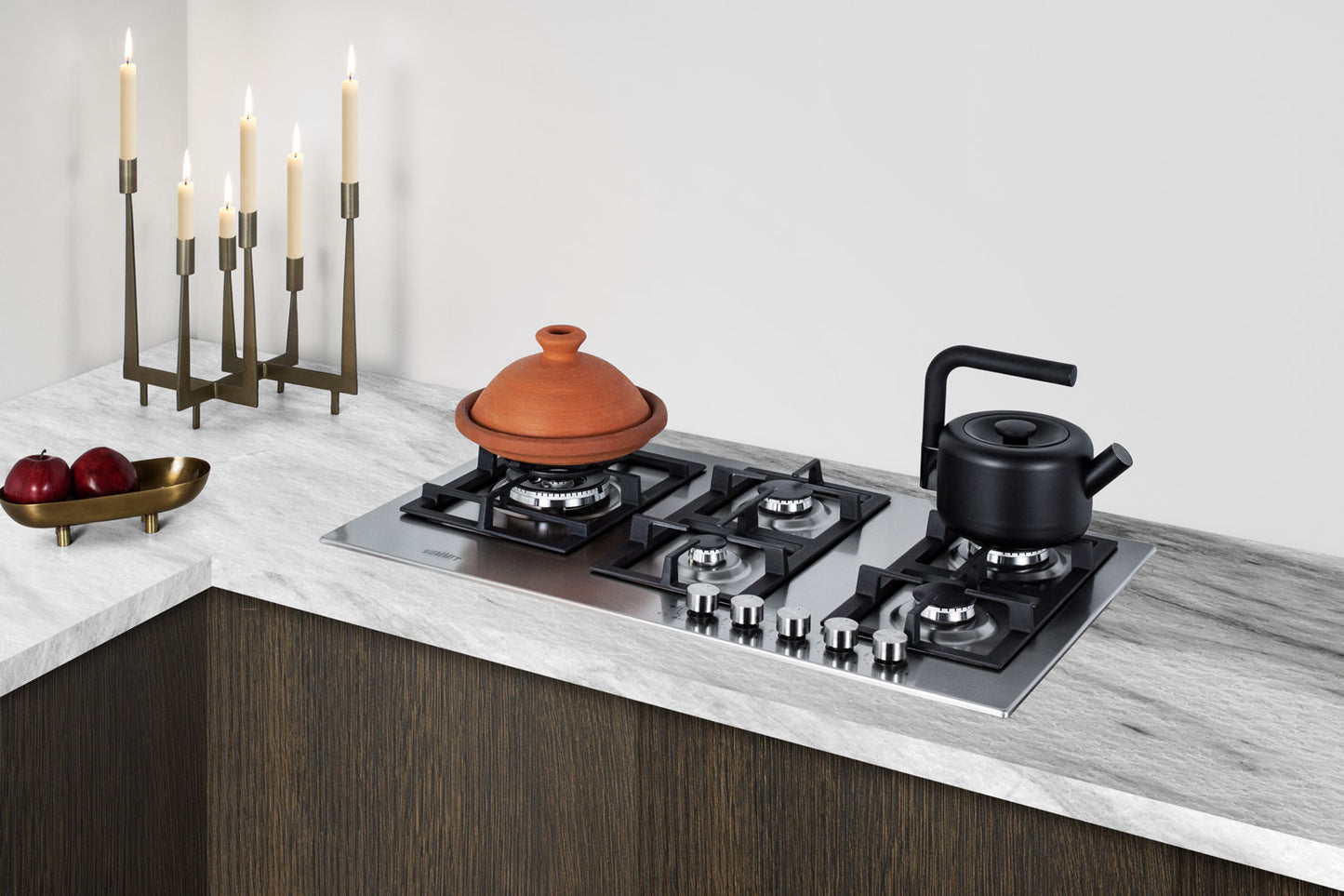 34-inch stainless steel five-burner cooktop installed in modern kitchen with marble countertop and dark wood cabinets