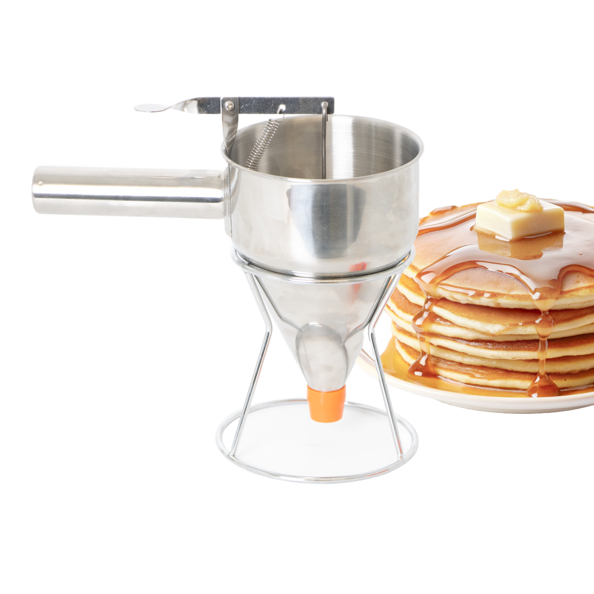 Stainless steel batter dispenser with stand and orange silicone tip next to stack of pancakes with syrup and butter