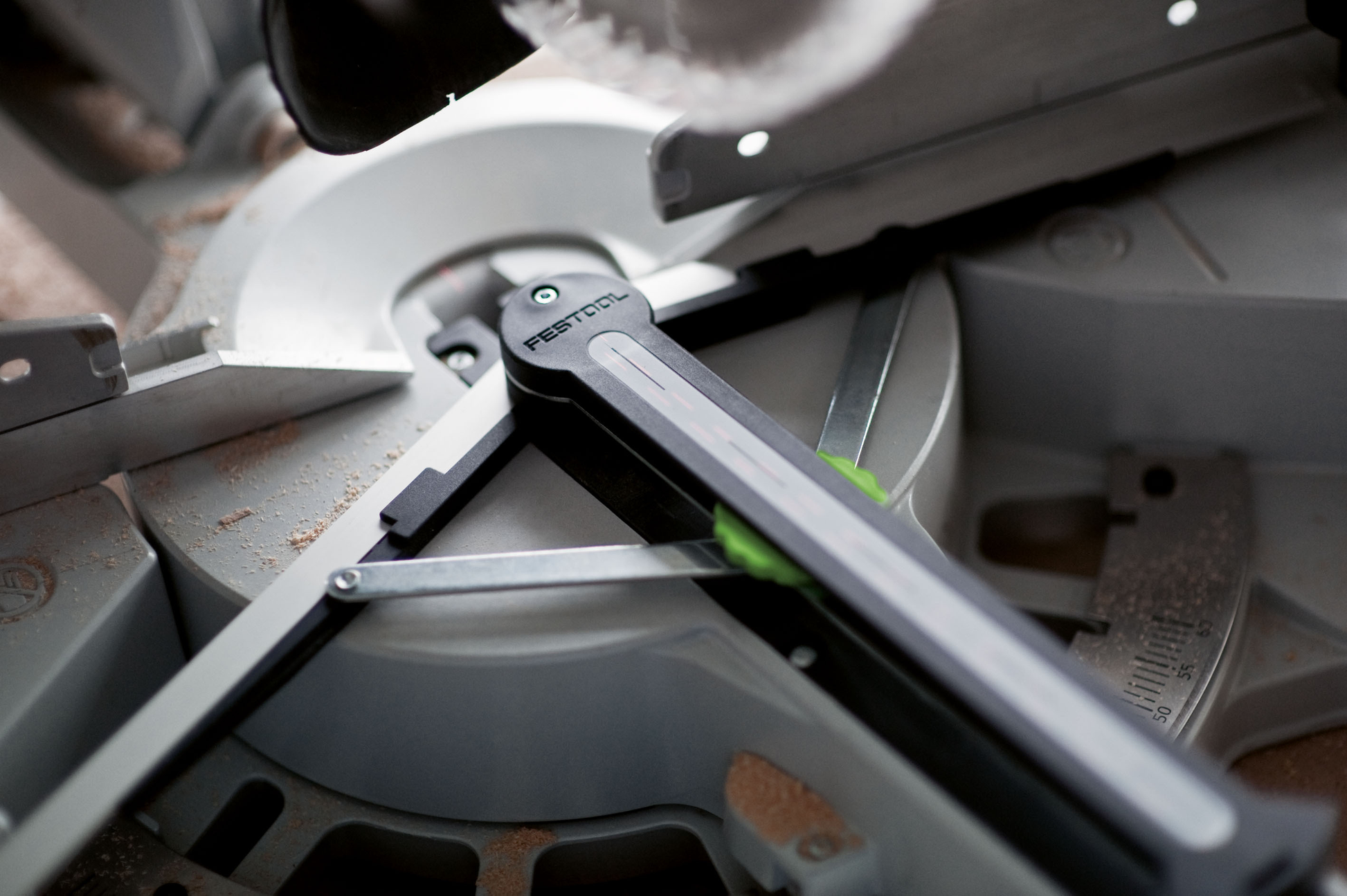 Close-up of Festool miter saw angle adjustment for precise cutting in power tools and home improvement collections