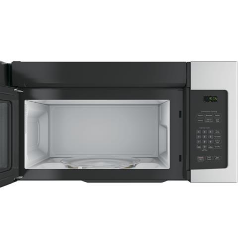 Over-the-range microwave with stainless steel finish, digital control panel, and open door showing interior turntable in kitchen setting