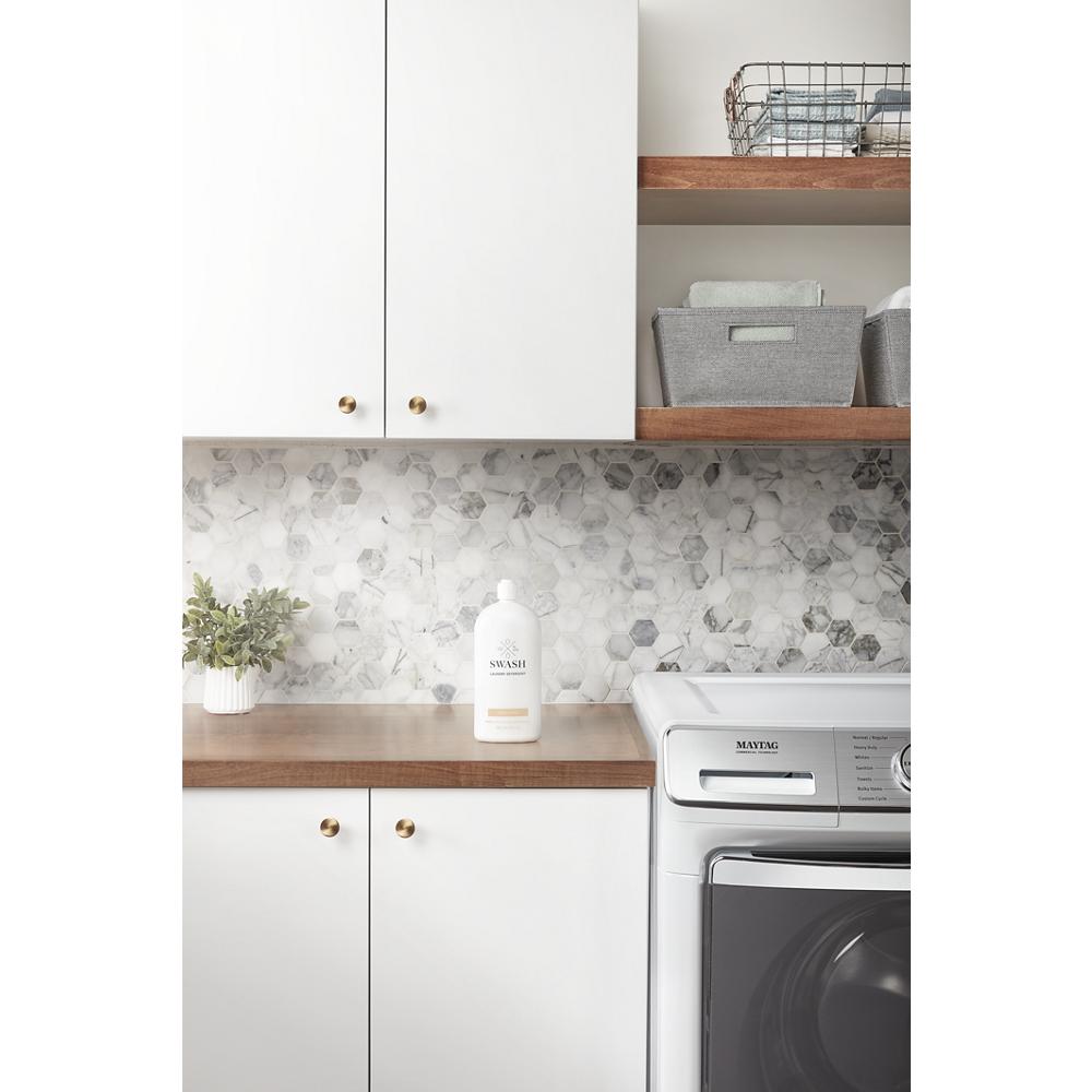 Modern laundry room with white cabinets, wooden shelves, marble backsplash, and front load electric dryer in Appliances collection